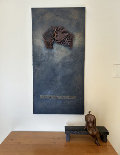 Sculpture by by Victoria B.C. Artist, Louise Monfette titled Waiting. Sculpture sitting on a table.